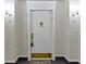Hallway with a white door with a gold lion door knocker and sconce lights at 8751 Jaffa Court E Dr # 17, Indianapolis, IN 46260