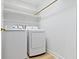 Laundry room with white washer and dryer and white shelves at 8751 Jaffa Court E Dr # 17, Indianapolis, IN 46260