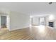 Bright, empty living room with new floors, white walls, and a fireplace at 8751 Jaffa Court E Dr # 17, Indianapolis, IN 46260
