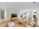 Staged living room with plush seating, fireplace, and adjacent dining room at 8751 Jaffa Court E Dr # 17, Indianapolis, IN 46260