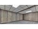 An unfinished basement offers a spacious area with wood paneling and gray vinyl floors at 8929 Lantern Ln, Indianapolis, IN 46256