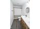 This bathroom features a single sink vanity with wood cabinets and a shower/tub combo at 9078 N River Chase Ln, McCordsville, IN 46055