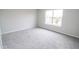 A carpeted bedroom featuring a window allowing in natural light at 9078 N River Chase Ln, McCordsville, IN 46055