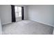 A carpeted bedroom featuring a window with black curtains allowing in natural light at 9078 N River Chase Ln, McCordsville, IN 46055