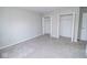 A spacious bedroom with plush gray carpet and double closets at 9078 N River Chase Ln, McCordsville, IN 46055