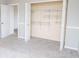 A bright bedroom featuring a large closet with shelving and soft gray carpet at 9078 N River Chase Ln, McCordsville, IN 46055