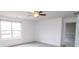Bright bedroom featuring neutral carpet, a ceiling fan, and a large window at 9078 N River Chase Ln, McCordsville, IN 46055