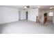 Large bonus room with neutral carpet, ceiling fan, and staircase to the second floor at 9078 N River Chase Ln, McCordsville, IN 46055