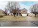 Inviting two-story home with a driveway, a mix of brick and siding, and lovely blue shutters at 9078 N River Chase Ln, McCordsville, IN 46055