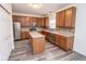 Bright, modern kitchen featuring a center island, stainless appliances, lots of cabinet storage, and wood-look floors at 9078 N River Chase Ln, McCordsville, IN 46055