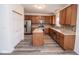 Spacious kitchen with stainless steel appliances, warm wood cabinets, and a functional center island perfect for cooking at 9078 N River Chase Ln, McCordsville, IN 46055