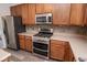 Modern kitchen featuring a stainless steel stove, microwave, refrigerator, and plenty of cabinet and counter space at 9078 N River Chase Ln, McCordsville, IN 46055