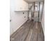 Utility room featuring wood vinyl flooring, white cabinets, water heater, and HVAC unit at 9078 N River Chase Ln, McCordsville, IN 46055