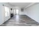 Spacious living room featuring modern gray floors, a fireplace, and large windows at 9078 N River Chase Ln, McCordsville, IN 46055