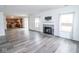 Open-concept living room showcasing gray floors, fireplace, and flow into the kitchen at 9078 N River Chase Ln, McCordsville, IN 46055