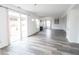 Large open living space with stylish wood-look flooring, modern decor, and lots of natural light at 9078 N River Chase Ln, McCordsville, IN 46055