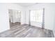 Open-concept living space featuring modern flooring and views of the entryway at 9078 N River Chase Ln, McCordsville, IN 46055
