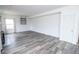 Spacious living area with wood-look flooring, modern shelving, and lots of space for entertaining at 9078 N River Chase Ln, McCordsville, IN 46055