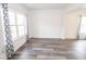 Spacious living room with large windows and contemporary flooring at 9078 N River Chase Ln, McCordsville, IN 46055