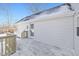 Backyard exterior showcasing a wood deck and snowy roof against a blue sky at 10539 Mcpherson St, Carmel, IN 46280