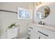 Bathroom features stylish vanity, sleek hardware, and a round mirror above the sink at 10539 Mcpherson St, Carmel, IN 46280