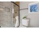 Modern bathroom with glass shower, sleek fixtures, and natural light from the window at 10539 Mcpherson St, Carmel, IN 46280