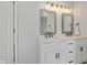 Bright bathroom features double vanity with stylish mirrors and modern lighting fixtures at 10539 Mcpherson St, Carmel, IN 46280