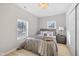 Serene bedroom featuring neutral decor, a comfortable bed, and ample natural light from two windows at 10539 Mcpherson St, Carmel, IN 46280