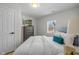 Cozy bedroom with a comfortable bed, complemented by a chest of drawers and natural light at 10539 Mcpherson St, Carmel, IN 46280