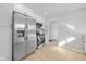 This kitchen features stainless steel appliances, white cabinets, and light-colored flooring at 10539 Mcpherson St, Carmel, IN 46280