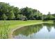 Scenic view of a calm pond surrounded by lush greenery, including a gazebo, perfect for nature lovers at 1148 Easy St # B, Greenwood, IN 46142