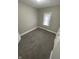 Well-lit bedroom with neutral carpet and closet space at 1207 N Kealing Ave, Indianapolis, IN 46201