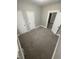 Functional bedroom space featuring neutral carpet, multiple doors, and closet at 1207 N Kealing Ave, Indianapolis, IN 46201