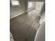 Spacious living room featuring gray wood-look floors and plenty of natural light at 1207 N Kealing Ave, Indianapolis, IN 46201