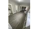 Versatile living space featuring gray wood-look floors and multiple entryways at 1207 N Kealing Ave, Indianapolis, IN 46201