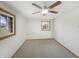 Minimalist bedroom featuring neutral carpet, two windows, and ceiling fan at 126 S Mustin Dr, Anderson, IN 46012