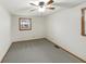 Simple bedroom with neutral carpet, ceiling fan, and natural light from two windows at 126 S Mustin Dr, Anderson, IN 46012