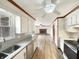 Well-lit kitchen with white cabinets, modern appliances, and view into the living room at 126 S Mustin Dr, Anderson, IN 46012