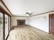 Bright living room features hardwood floors, a brick fireplace, and a sliding glass door at 126 S Mustin Dr, Anderson, IN 46012