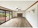 Living room featuring a fireplace, sliding door access to the back deck, and neutral colored wood trim and ceiling fan at 126 S Mustin Dr, Anderson, IN 46012