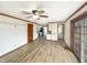 Open-concept living area with hardwood floors, a ceiling fan, and access to the kitchen at 126 S Mustin Dr, Anderson, IN 46012