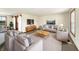 A spacious, sunlit living room featuring neutral furniture and decor at 126 S Mustin Dr, Anderson, IN 46012