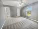 Bright bedroom with a ceiling fan, a window with a view, and neutral carpet at 12840 Patrick Ct, Fishers, IN 46038