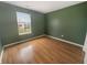 Empty bedroom with hardwood floors and a bright window showcasing natural light at 12840 Patrick Ct, Fishers, IN 46038