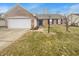 A charming one-story home with a two-car garage and manicured lawn on a sunny day at 12840 Patrick Ct, Fishers, IN 46038