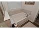 Relaxing bathroom featuring a soaking tub and neutral decor for a calming spa experience at 1307 Peregrine Ln, Greenwood, IN 46143