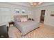 Spacious bedroom with carpet floor, large bed and a view to the exterior and to the bathroom at 1307 Peregrine Ln, Greenwood, IN 46143