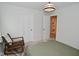 Bedroom view of the wall featuring an armchair, a bed and a door at 1307 Peregrine Ln, Greenwood, IN 46143