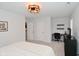 A modern bedroom with a contemporary light fixture, neutral walls, and carpet flooring at 1307 Peregrine Ln, Greenwood, IN 46143
