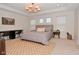 Bright bedroom features large bed, neutral decor and a work space at 1307 Peregrine Ln, Greenwood, IN 46143